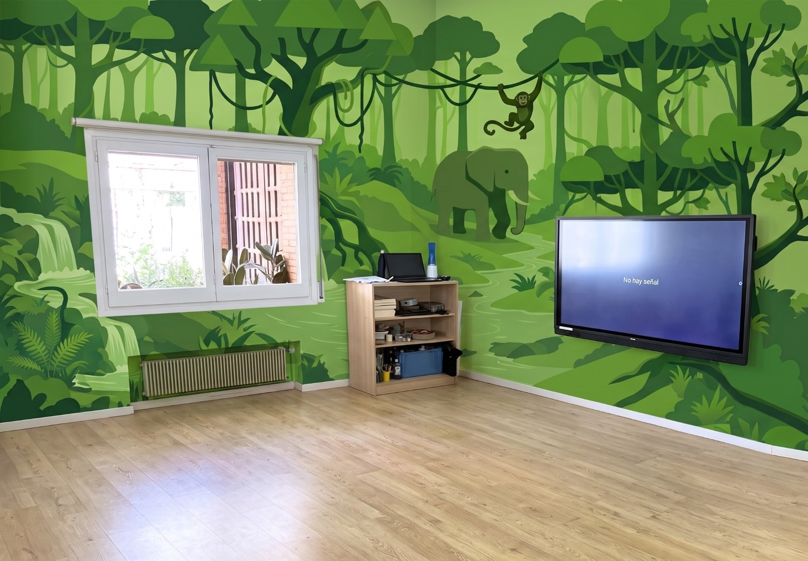 Jungle mural with an elephant and a monkey in a classroom