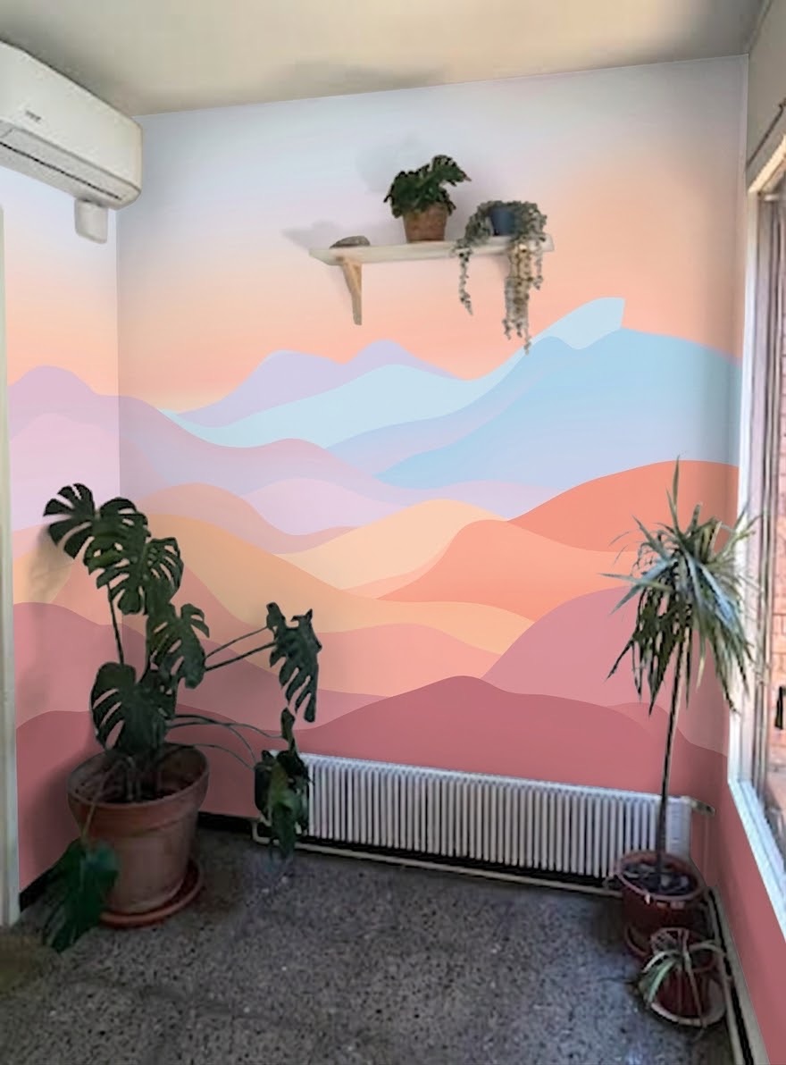 Sunset mountain mural in a plant-filled reading nook
