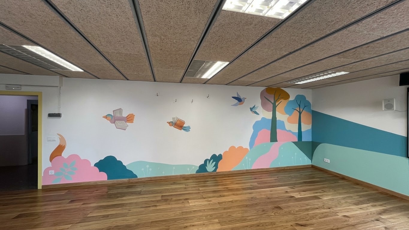 Pastel nature mural with birds, trees and hills in a classroom
